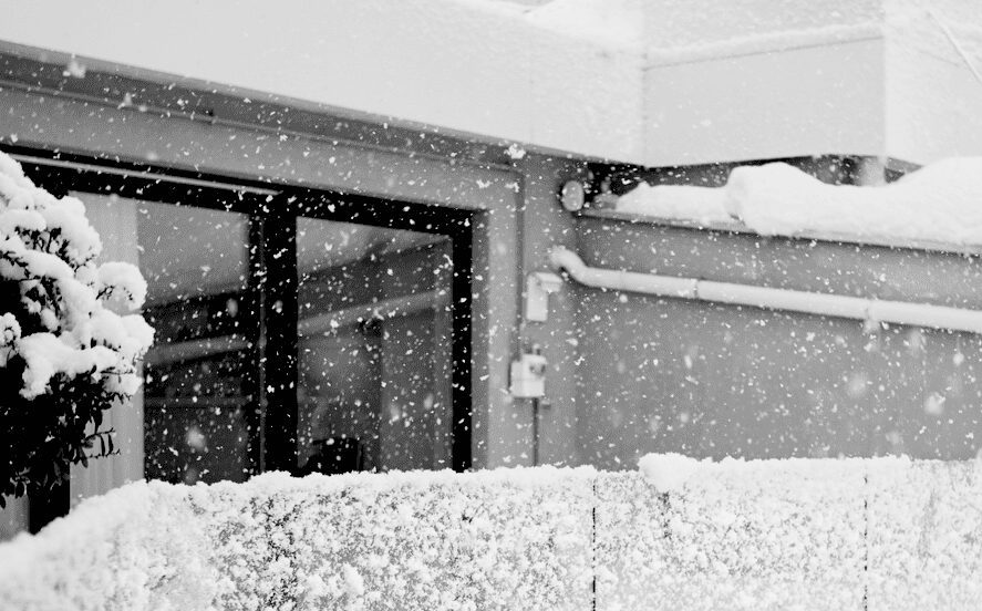 heavy snowfall on apartments in black and white